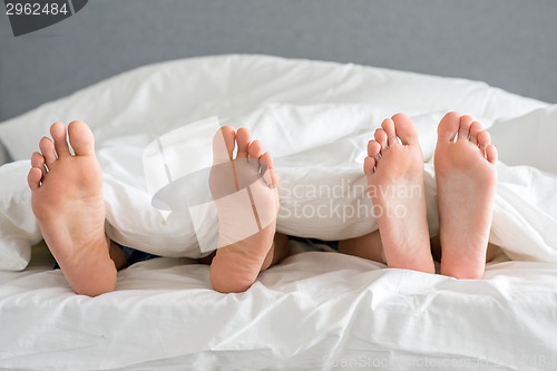 Image of Close up Partners Soles on White Bed