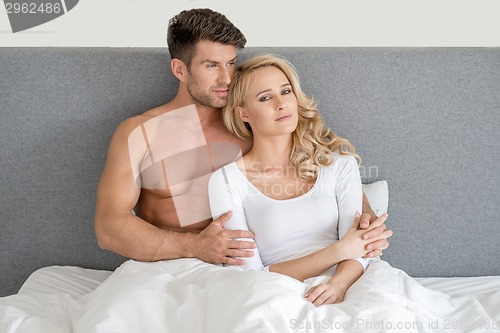 Image of Middle Age Romantic Couple on Bed Fashion Shoot