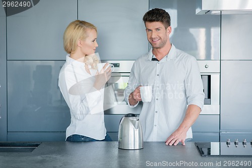 Image of Attractive couple enjoying their morning coffee