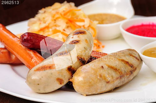 Image of German sausage with cabbage and sauces