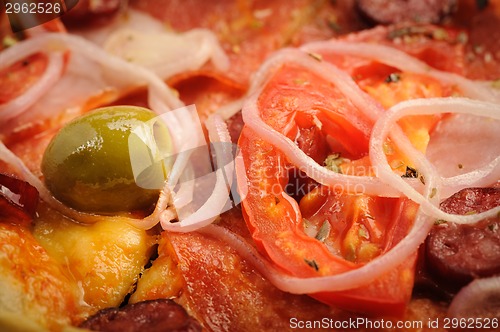 Image of Pizza with tomato, salami, peppeeoni, olives and yellow hot pepper
