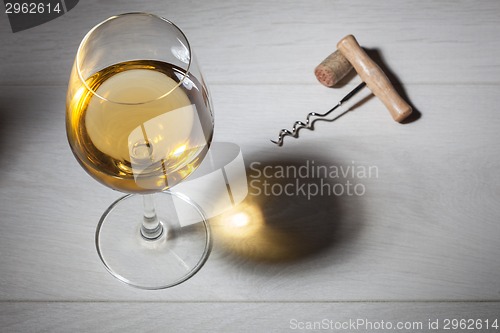 Image of Glass of white wine on wooden table