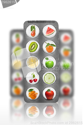 Image of Natural pills with vitamins and fruits isolated