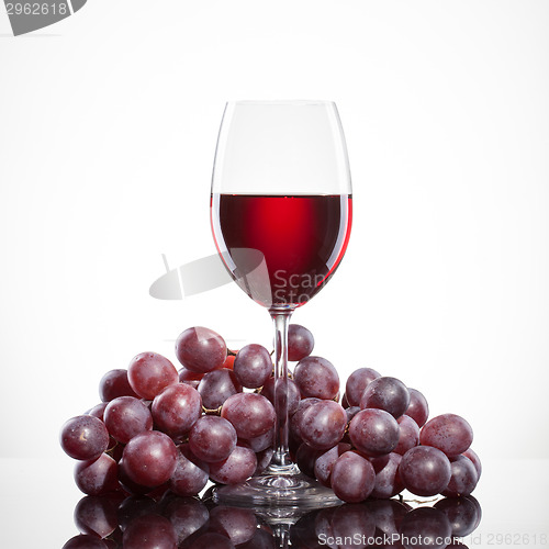 Image of Glass of red wine and grape isolated on white