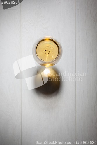 Image of Glass of white wine on wooden table