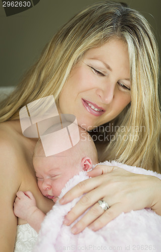 Image of Young Beautiful Mother Holding Her Precious Newborn Baby Girl