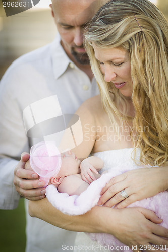 Image of Beautiful Young Couple Holding Their Newborn Baby Girl