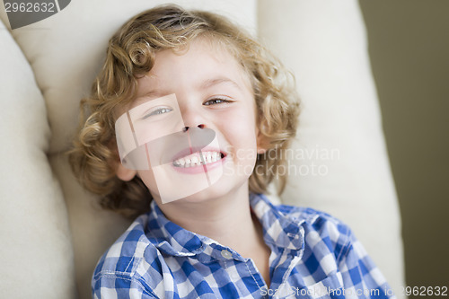 Image of Cute Blonde Boy Smiling Sitting in Chair