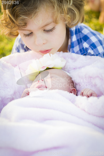 Image of Young Boy Gazing at His Newborn Baby Girl Sister