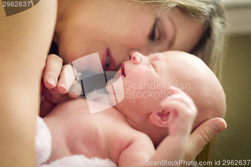 Image of Young Beautiful Mother Holding Her Precious Newborn Baby Girl