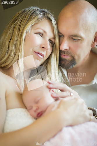 Image of Beautiful Young Couple Holding Their Newborn Baby Girl