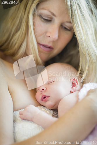 Image of Young Beautiful Mother Holding Her Precious Newborn Baby Girl