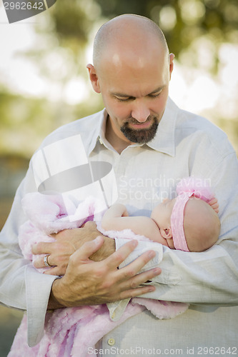 Image of Young Handsome Father Holds His Newborn Baby Girl