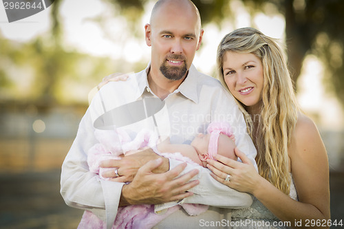Image of Beautiful Young Couple Holding Their Newborn Baby Girl