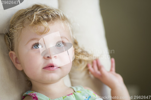 Image of Adorable Blonde Haired and Blue Eyed Little Girl in Chair