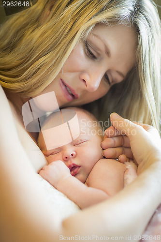 Image of Young Beautiful Mother Holding Her Precious Newborn Baby Girl