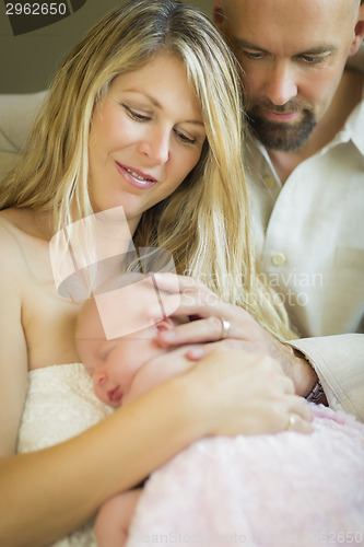 Image of Beautiful Young Couple Holding Their Newborn Baby Girl