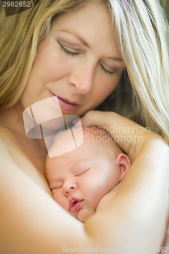 Image of Young Beautiful Mother Holding Her Precious Newborn Baby Girl