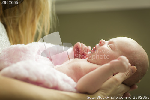 Image of Hands of Mother Holding Her Newborn Baby Girl