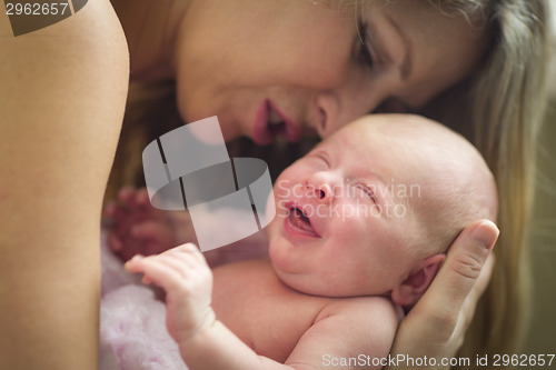 Image of Young Beautiful Mother Holding Her Precious Newborn Baby Girl