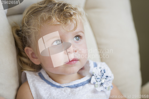 Image of Adorable Blonde Haired and Blue Eyed Little Girl in Chair