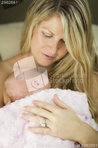 Image of Young Beautiful Mother Holding Her Precious Newborn Baby Girl