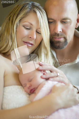 Image of Beautiful Young Couple Holding Their Newborn Baby Girl