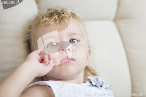 Image of Adorable Blonde Haired and Blue Eyed Little Girl in Chair