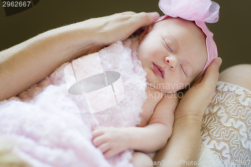 Image of Hands of Mother Holding Her Newborn Baby Girl