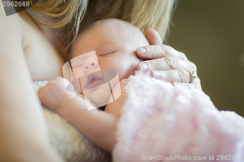 Image of Hands of Mother Holding Her Newborn Baby Girl