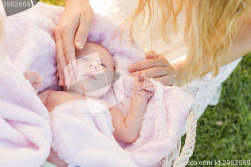 Image of Hands of Mother Caressing Her Newborn Baby Girl