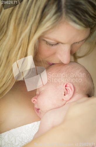 Image of Young Beautiful Mother Holding Her Precious Newborn Baby Girl