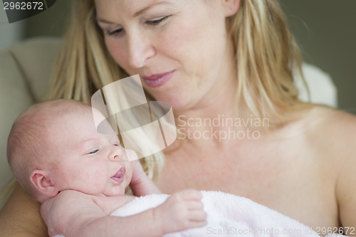 Image of Young Beautiful Mother Holding Her Precious Newborn Baby Girl