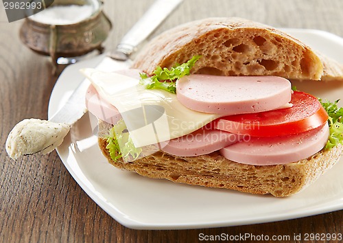 Image of sandwich with sausage and tomato