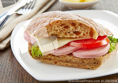 Image of sandwich with sausage and tomato