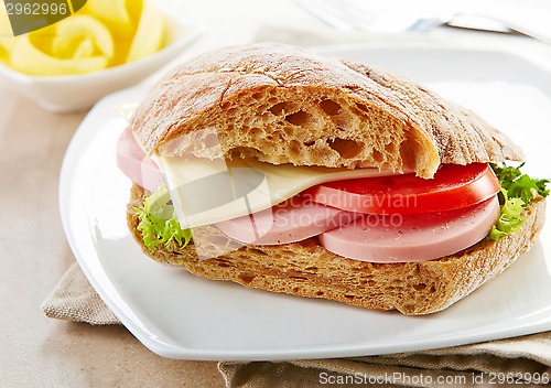 Image of sandwich with sausage and tomato
