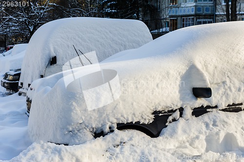 Image of vehicles covered with snow