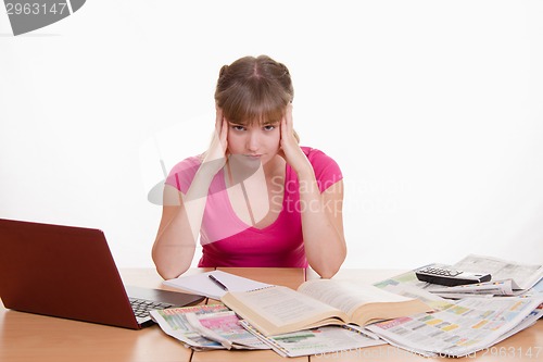 Image of The girl has a headache from job search