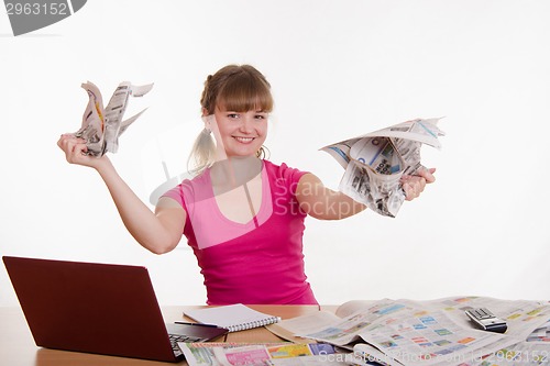 Image of The girl behind the desk tearing paper