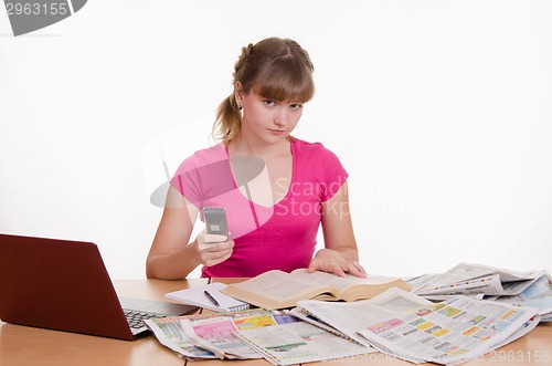 Image of Athletic woman dials the phone book