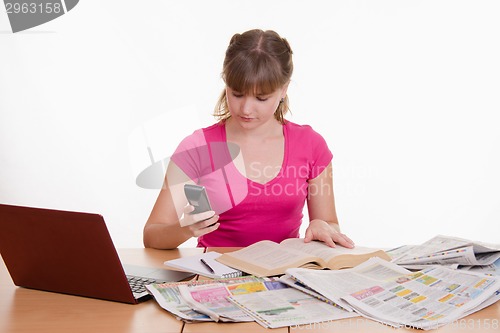 Image of Woman dials the phone book