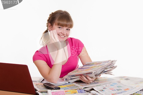 Image of Happy girl with a stack of newspapers