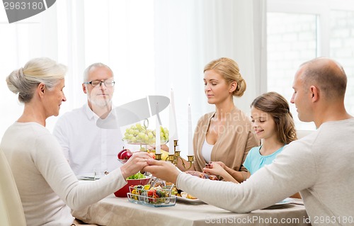 Image of smiling family having holiday dinner at home