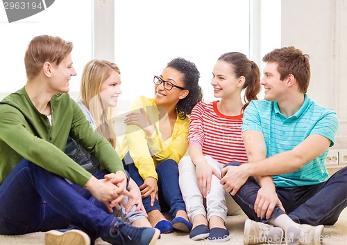 Image of five smiling teenagers having fun at home