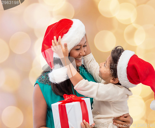 Image of happy mother and child girl with gift box