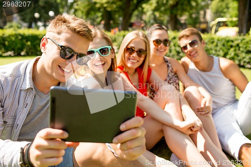 Image of smiling friends with tablet pc making selfie