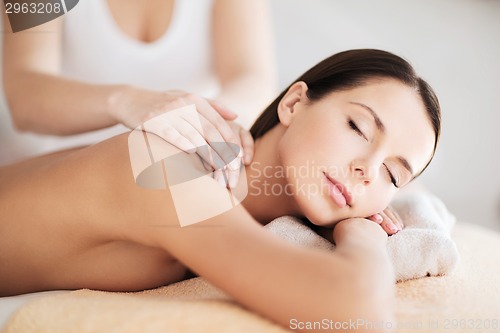 Image of beautiful woman in spa having massage