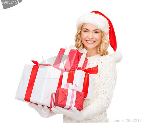 Image of woman in santa helper hat with many gift boxes