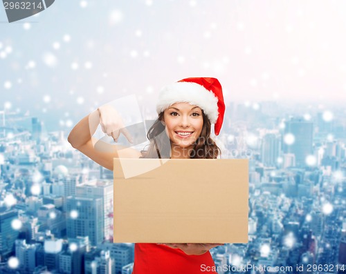 Image of smiling woman in santa helper hat with parcel box