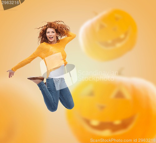 Image of smiling young woman jumping in air